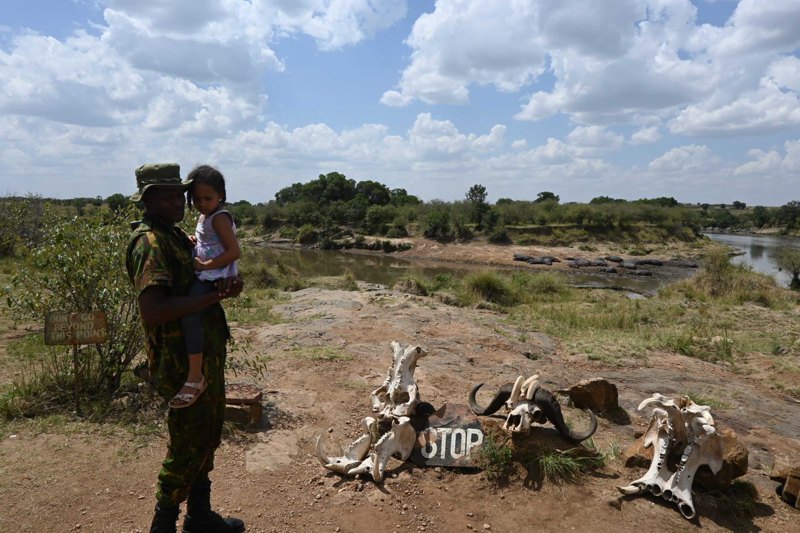 Rugrat#2 learning about animal skulls from our park ranger guide at the bank of the Mara River. Rugrat#2 learning about animal skulls from our park ranger guide at the bank of the Mara River.